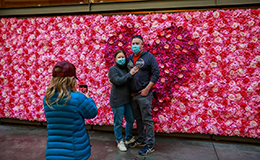 parents take a picture in front of flowers at sf ferry building