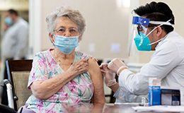 senior living community resident receiving vaccine