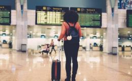 woman stands in an airport