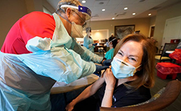 healthcare worker receiving 2nd dose of vaccine