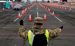 national guard directing traffic at vaccine clinic