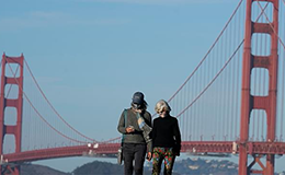 two people standing in front of the golden gate bridge