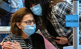 woman hugging her daughter after reciving Johnson and Johnson vaccine