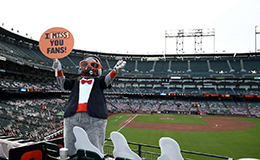 SF Giants' mascot Lou Seal in the stand with cardboard cutouts